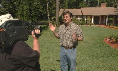 faculty member hosting television show in front of a videocamera